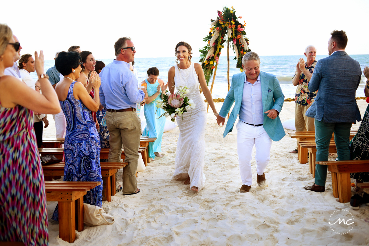 Beach bride and groom exit. Blue Diamond Luxury Boutique Hotel Wedding in Mexico. Martina Campolo Photography