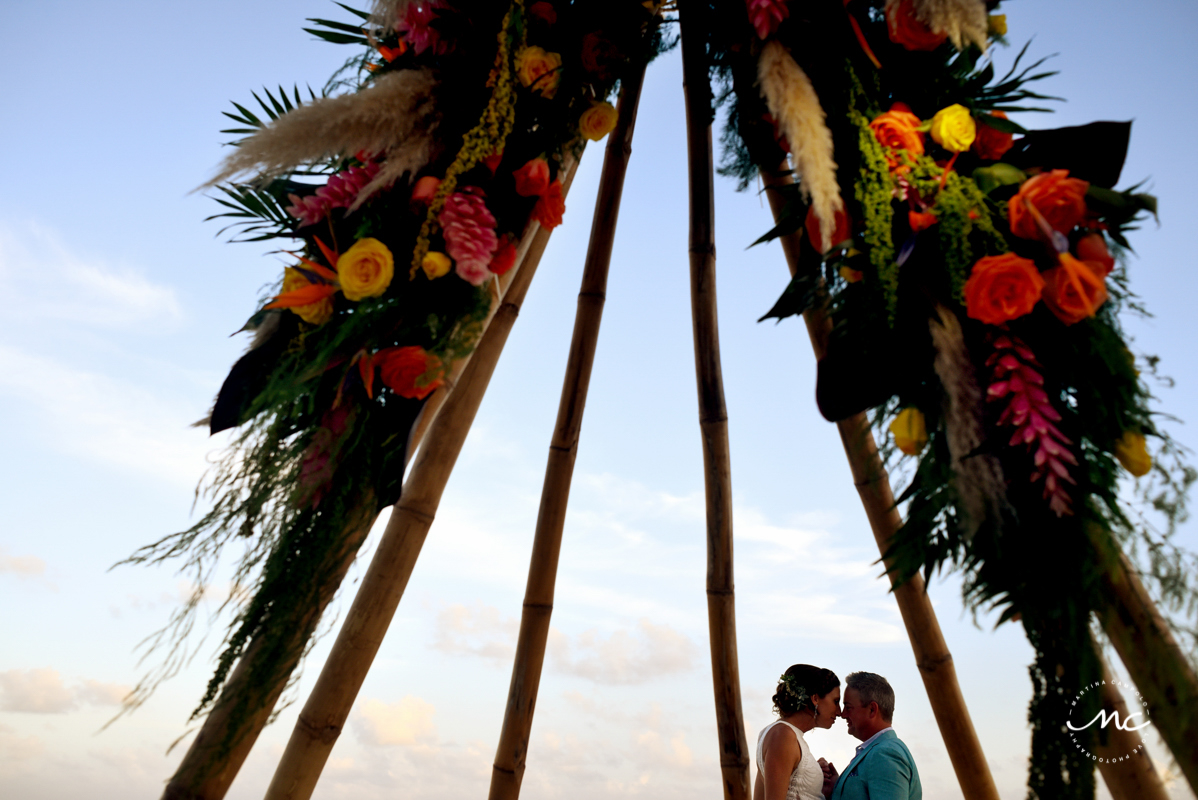 Bride and groom under tipi wedding arch at Blue Diamond Luxury Boutique Hotel, Mexico. Martina Campolo Photography