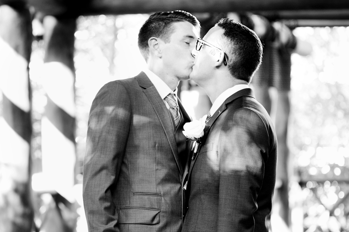 Grooms kiss. Gay destination wedding photography by Martina Campolo Photography in Playa del Carmen, Mexico