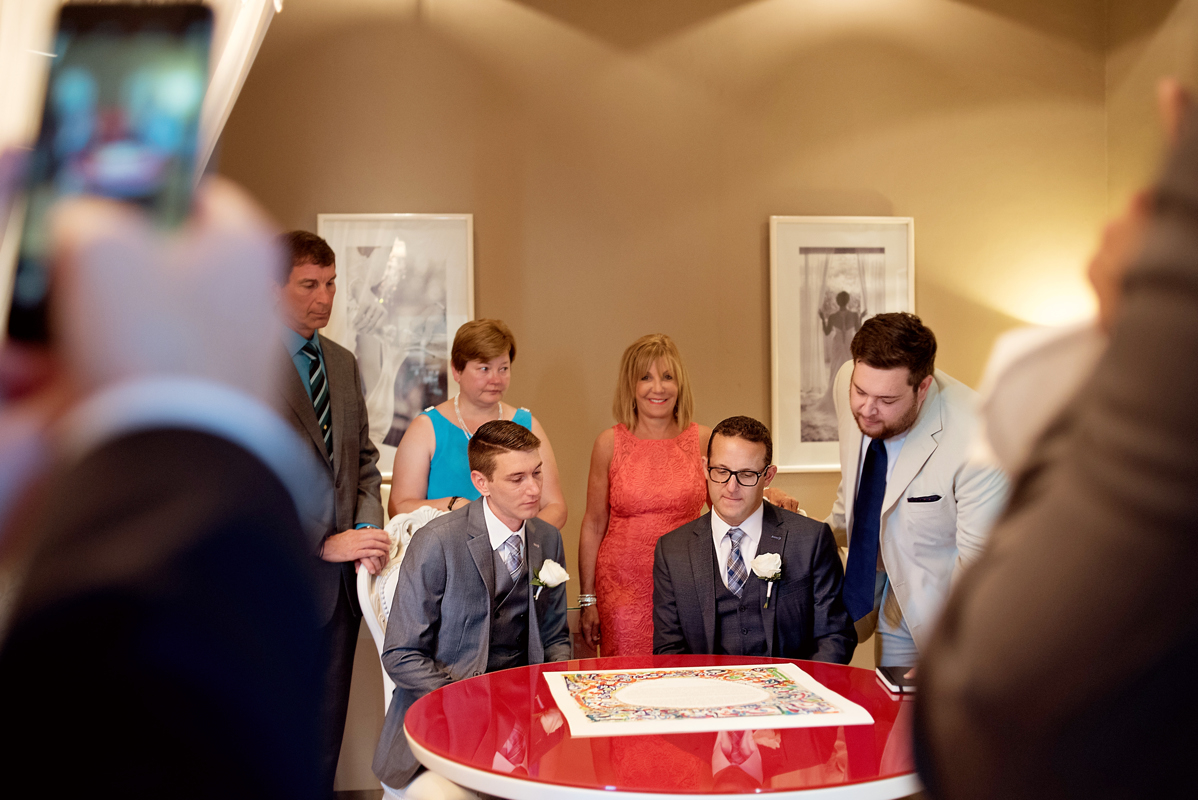 Ketubah signing moment by Martina Campolo Jewish Wedding Photography in Riviera Maya, Mexico