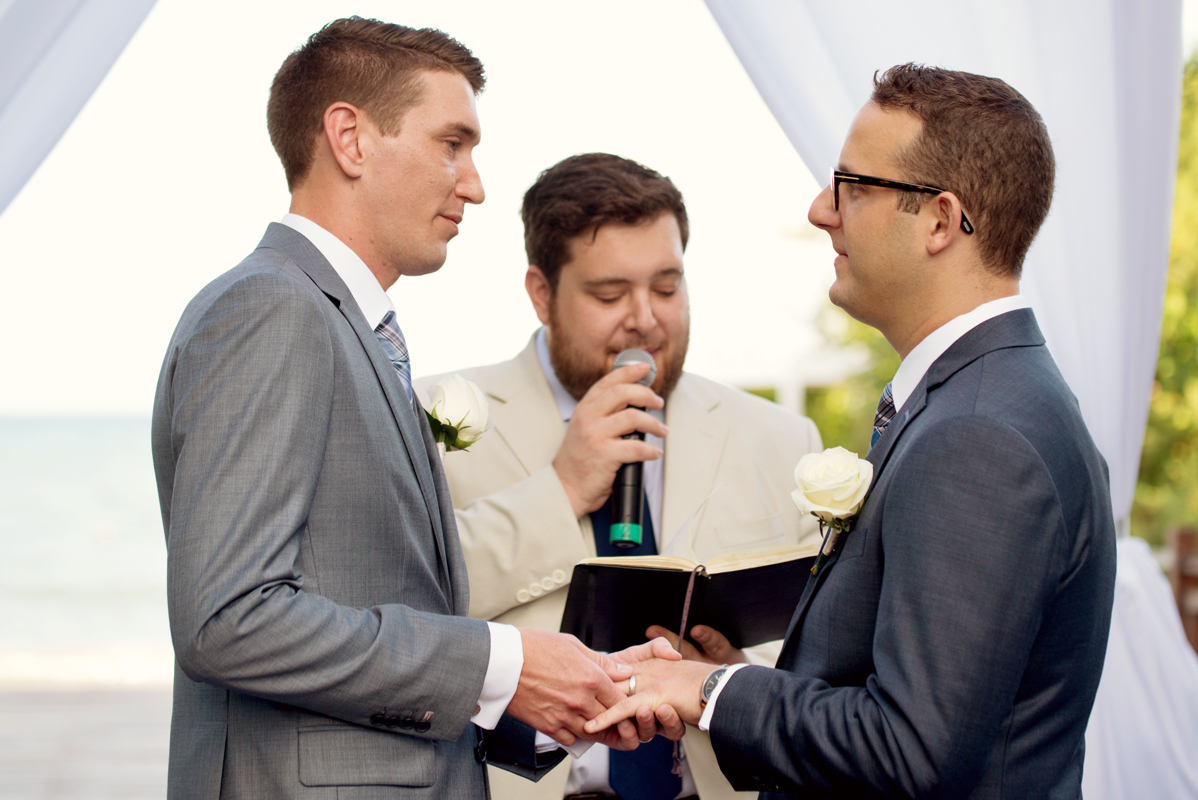 Ring exchange moment at Paradisus Playa del Carmen Gay Destination Wedding. Martina Campolo Photography