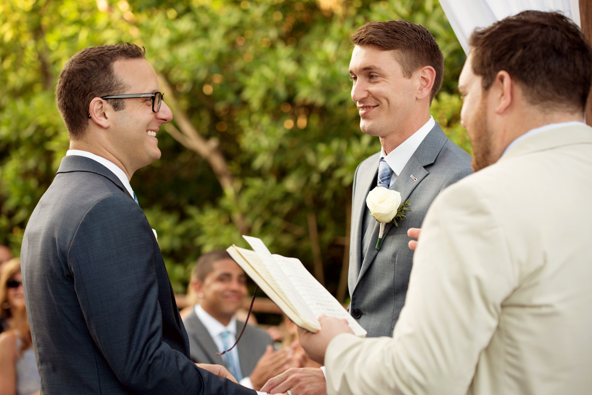 Romantic gay wedding ceremony moment by Martina Campolo Photography in Riviera Maya, Mexico