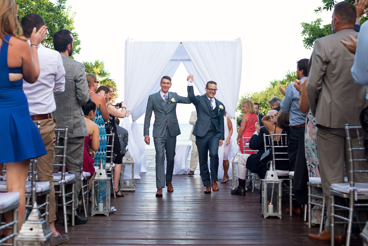 Groom and groom happy exit. Gay Jewish destination wedding in Playa del Carmen, Mexico by Martina Campolo Photography