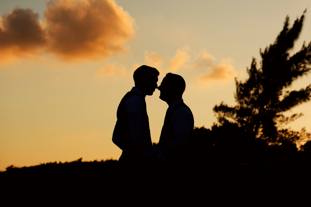 Groom and groom silhouettes at sunset in Playa del Carmen, Mexico. Martina Campolo LGBT Wedding Photography