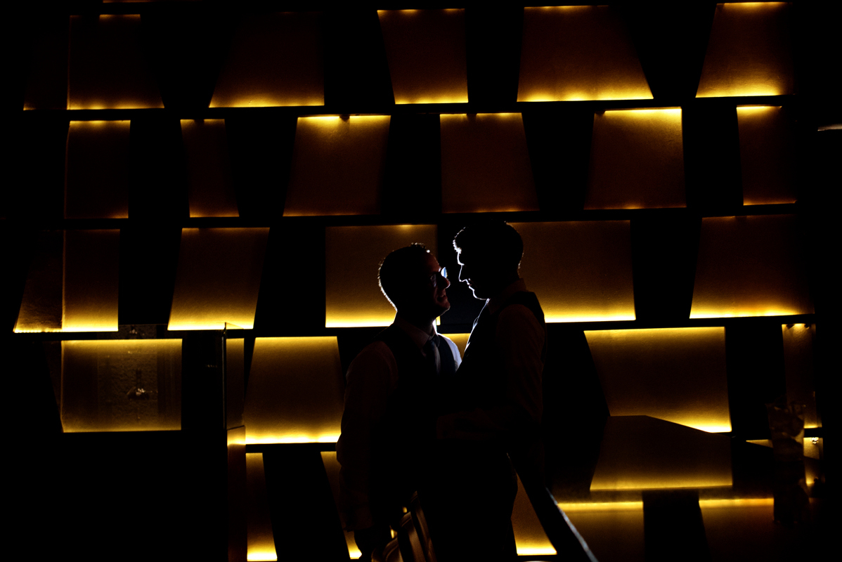 Groom and groom silhouettes at Paradisus Playa del Carmen lobby by Martina Campolo Mexico Wedding Photography