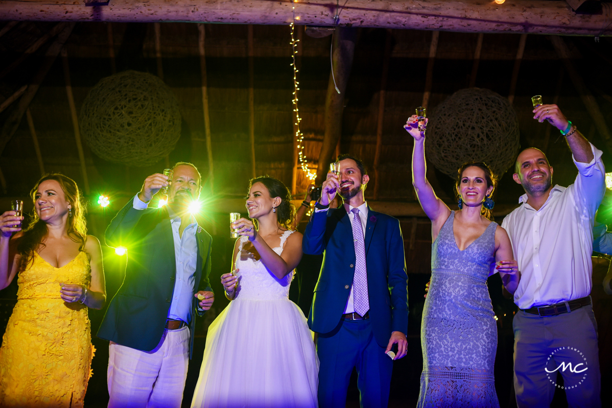 Cheers. Wedding Reception moment at Blue Venado Beach in Mexico. Martina Campolo Photography