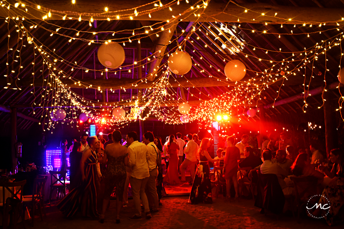 Packed dance floor with bistro lights at Blue Venado Weddings by Martina Campolo Photography