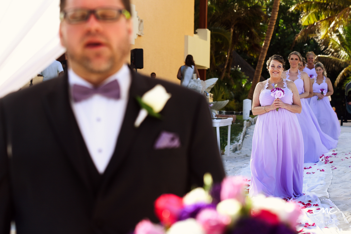 Lilac bridesmaids walk down the aisle. Now Sapphire Riviera Cancun wedding by Martina Campolo Photography