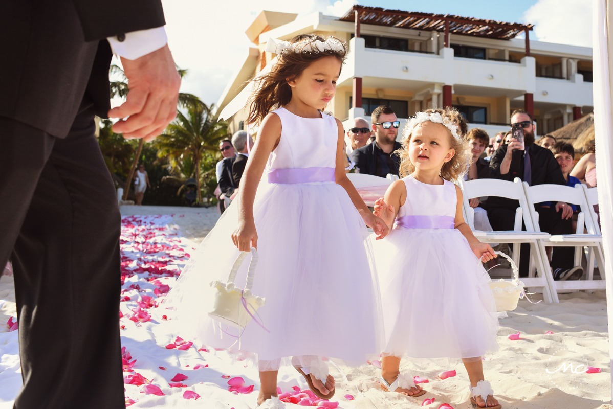 Lilac flower girls walk down the aisle at Now Sapphire, Mexico. Martina Campolo Wedding Photography