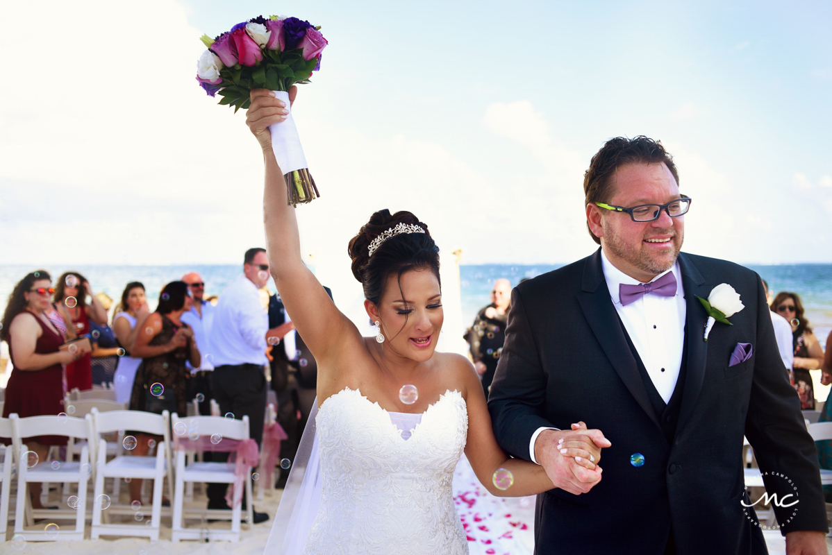 Bride and groom exit. Now Sapphire Riviera Cancun wedding by Martina Campolo Photography