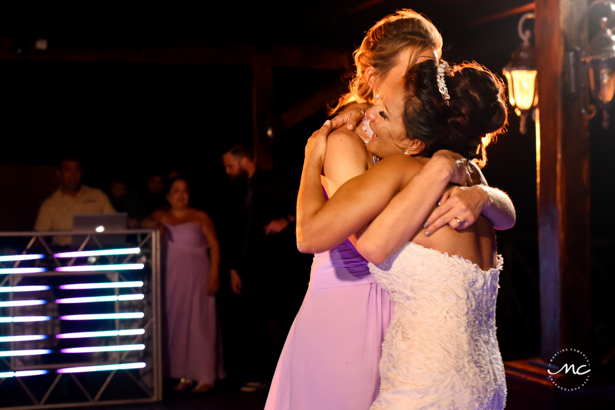 Bride and bridesmaids hug. Now Sapphire wedding reception by Martina Campolo Photography