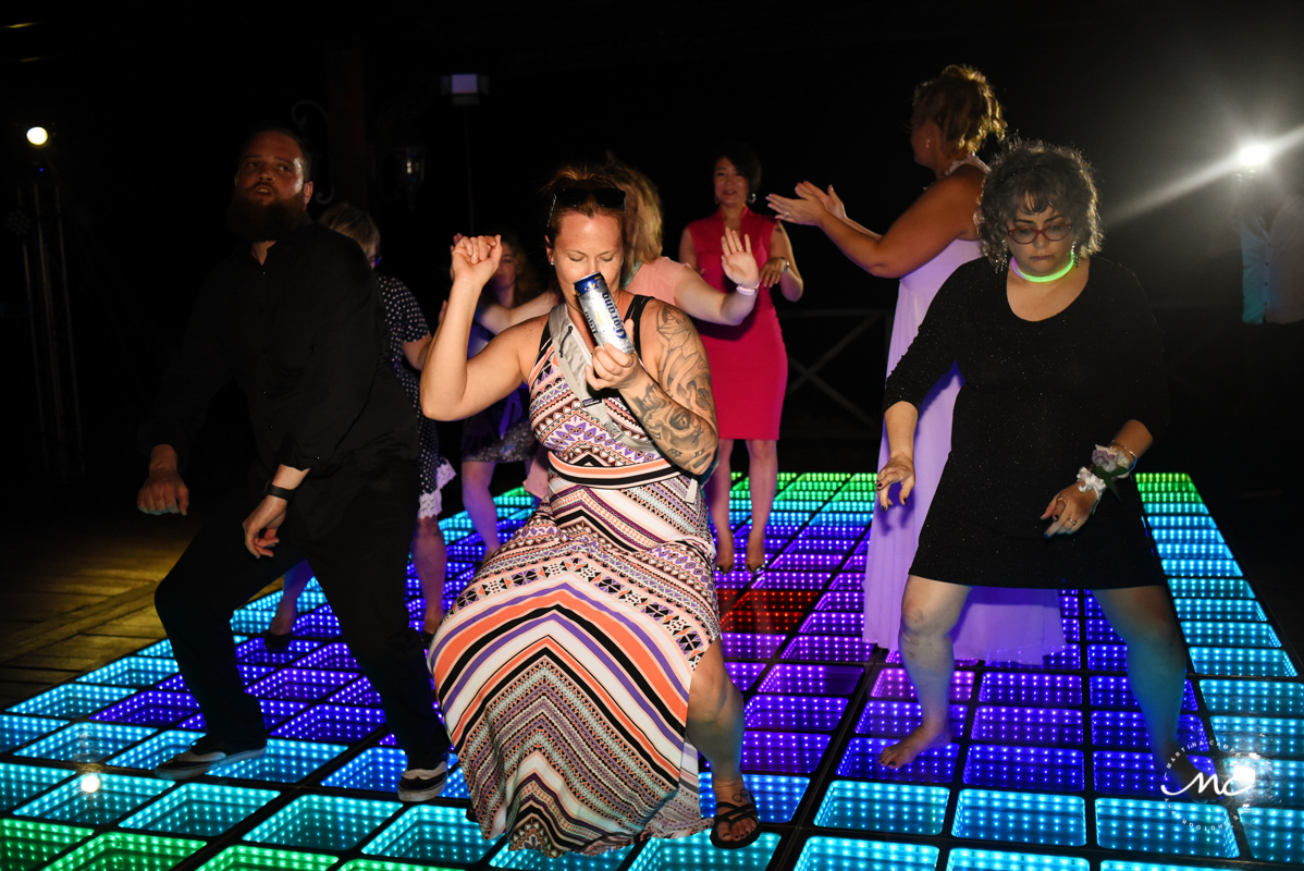 Wedding guests dance over infinity dance floor at Now Sapphire Riviera Cancun. Martina Campolo Photography