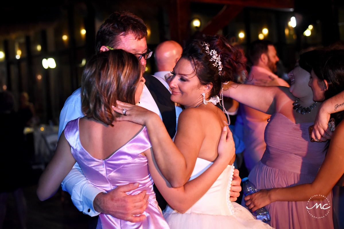 Bride and groom and daughter hug at Now Sapphire Wedding reception by Martina Campolo Photography