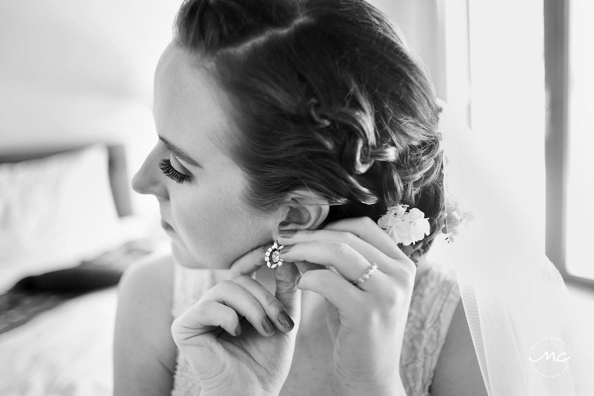 Black and white photo of bride wearing her earrings. Hacienda del Mar wedding in Mexico by Martina Campolo Photography