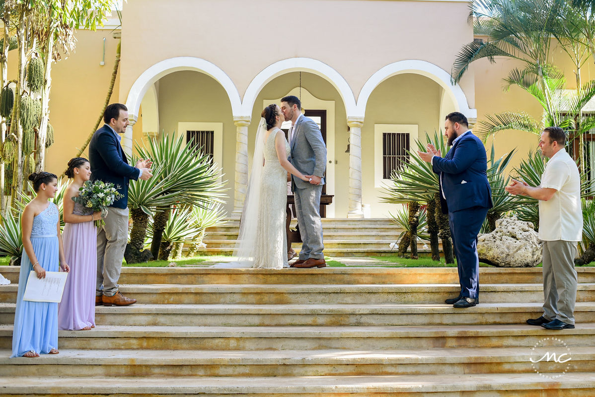 You may kiss the bride moment. Hacienda del Mar garden wedding in Puerto Aventuras, Mexico. Martina Campolo Photography