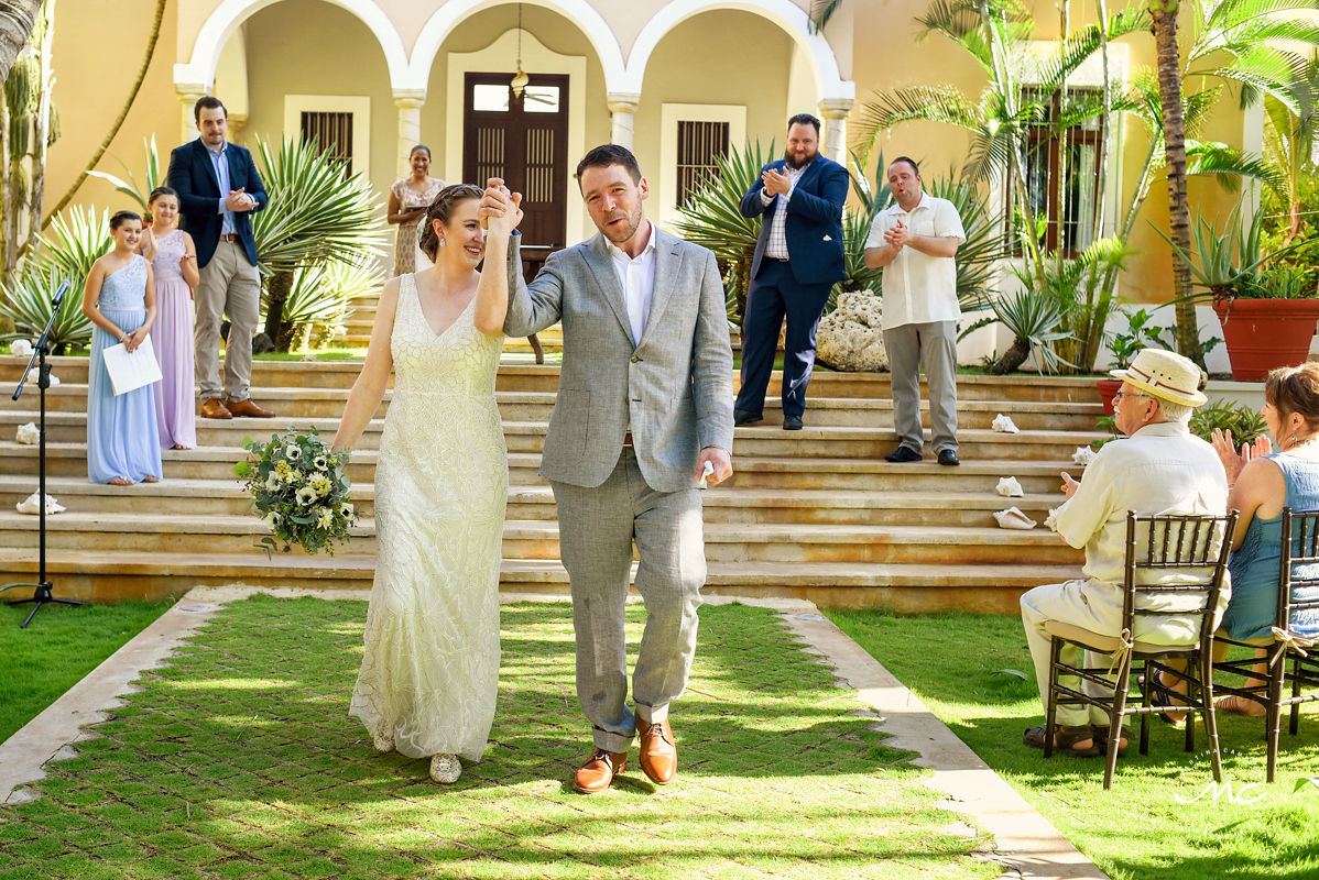 Bride and groom ceremony exit. Hacienda del Mar, Puerto Aventuras, Mexico. Martina Campolo Wedding Photography