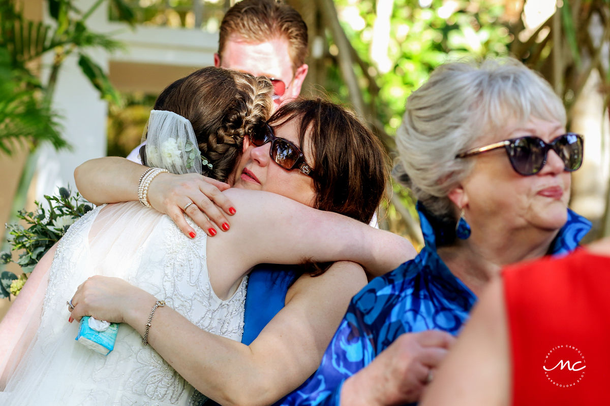 Bride and wedding guests hug. Hacienda del Mar, Riviera Maya, Mexico. Martina Campolo Photography