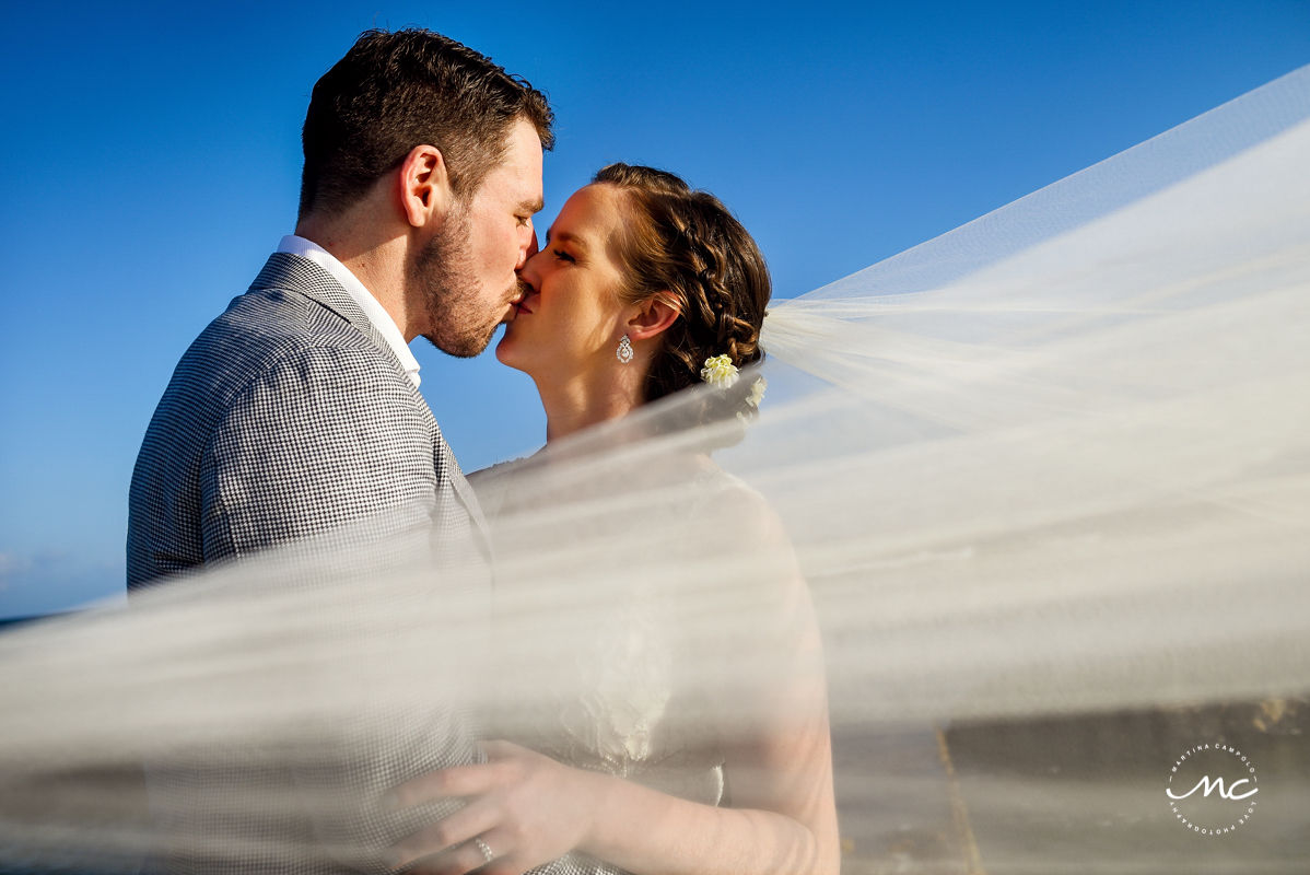 Veil shot. Bride and groom kiss. Hacienda del Mar wedding in Puerto Aventuras, Mexico. Martina Campolo Photography