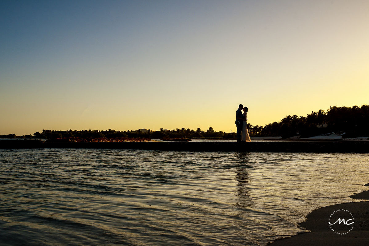 Bride and groom kiss on pier at Hacienda del Mar, Puerto Aventuras, Mexico. Martina Campolo Destination Wedding Photography